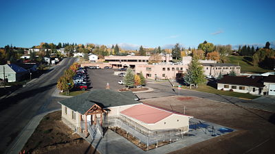 A distant view of Kemmerer Pharmacy and the community on clear, blue sky day