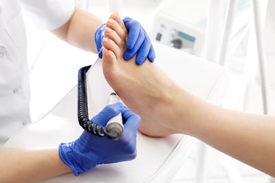 A medical professional is using hospital equipment to examine a patient\&apos;s foot