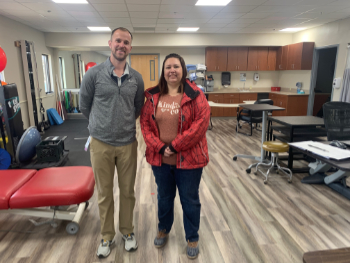 Picture of Physical Therapist Trent and patient Charlene Smith smiling.